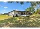 The spacious backyard has a screened porch, shade trees and plenty of room to enjoy at 2845 County Road 523, Wildwood, FL 34785