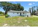 Beautiful single-story home with manicured lawn, and an attached garage in a rural setting at 2845 County Road 523, Wildwood, FL 34785