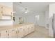 Spacious kitchen with bright cabinets and countertops, with open view to the living room at 2845 County Road 523, Wildwood, FL 34785