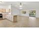 Open-concept living space with neutral tile flooring and view of the kitchen and sliding glass doors at 2845 County Road 523, Wildwood, FL 34785
