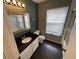 Modern bathroom with granite counters, white cabinets, and contemporary fixtures at 3041 Bloomsbury Dr, Kissimmee, FL 34747