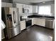 Modern kitchen featuring stainless steel appliances, white cabinets, and dark countertops at 3041 Bloomsbury Dr, Kissimmee, FL 34747