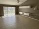 Large living room with ceramic tile flooring and sliding glass doors to lanai at 3041 Bloomsbury Dr, Kissimmee, FL 34747