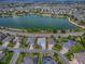 A bird's eye view shows the property's location near a tranquil lake in a friendly neighborhood at 3136 Vandenberg Ct, The Villages, FL 32163