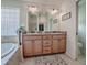 Bathroom featuring a soaking tub and a double sink vanity with a view into a walk-in closet at 3136 Vandenberg Ct, The Villages, FL 32163