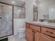 Well-lit bathroom with a glass shower and wooden cabinets at 3136 Vandenberg Ct, The Villages, FL 32163