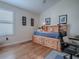 This bedroom boasts wood floors, a built-in headboard with storage, and natural light at 3136 Vandenberg Ct, The Villages, FL 32163