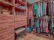 This is a walk-in closet with custom wood shelving, drawers, and hanging racks at 3136 Vandenberg Ct, The Villages, FL 32163