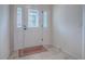 Bright foyer featuring a decorative front door and sidelights, tile flooring, and neutral wall color at 3136 Vandenberg Ct, The Villages, FL 32163