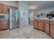 This is a kitchen with stainless steel refrigerator and tile floor at 3136 Vandenberg Ct, The Villages, FL 32163