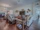 Spacious living room with hardwood floors, comfortable seating, and a ceiling fan, great for entertaining guests at 3136 Vandenberg Ct, The Villages, FL 32163