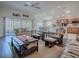 Inviting living room features hardwood floors, a ceiling fan, and sliding glass doors with a view of the lanai at 3136 Vandenberg Ct, The Villages, FL 32163