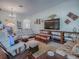 Comfortable living room featuring hardwood floors, cozy seating, and tasteful décor, perfect for Gathering gatherings at 3136 Vandenberg Ct, The Villages, FL 32163