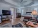 Spacious Main bedroom with a dark wood bed frame and a television at 3136 Vandenberg Ct, The Villages, FL 32163