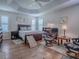 The Main bedroom features a dark wood bed frame and dressers and has a fan on the ceiling at 3136 Vandenberg Ct, The Villages, FL 32163