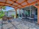 Enjoy outdoor dining on this patio with a pergola, brick pavers, and lush landscaping at 3136 Vandenberg Ct, The Villages, FL 32163