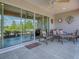 This screened patio features lots of seating, a ceiling fan, and beautiful outdoor views at 3136 Vandenberg Ct, The Villages, FL 32163