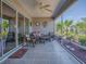 This screened patio features lots of seating, a ceiling fan, and beautiful outdoor views at 3136 Vandenberg Ct, The Villages, FL 32163