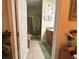 Open bathroom with double vanity, tiled floors, and shower with glass door at 3205 Sonesta Ct # B, Clermont, FL 34711