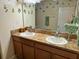 Well-lit bathroom features double sinks, a vanity with cabinets, and decorative wall art at 3205 Sonesta Ct # B, Clermont, FL 34711