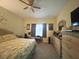 Spacious bedroom featuring a king bed, large dresser, ceiling fan and natural light for a relaxing ambiance at 3205 Sonesta Ct # B, Clermont, FL 34711