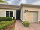 A front exterior view of a well-kept home with desert landscaping, stone-paved driveway, and a 2-car garage at 3205 Sonesta Ct # B, Clermont, FL 34711