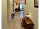 Inviting hallway featuring tile flooring, neutral walls, and a clear view into the brightly lit living area at 3205 Sonesta Ct # B, Clermont, FL 34711