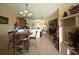 Open-concept area combining kitchen and dining, with a chandelier, breakfast bar, and ample counter space at 3205 Sonesta Ct # B, Clermont, FL 34711