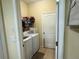 Efficient laundry room with washer, dryer, and shelving for storage at 3205 Sonesta Ct # B, Clermont, FL 34711