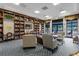 Inviting library with bookshelves, comfortable seating, and a cozy atmosphere for reading and relaxation at 3205 Sonesta Ct # B, Clermont, FL 34711