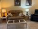 Cozy living room with plush seating, a glass-top coffee table, and neutral decor for a welcoming atmosphere at 3205 Sonesta Ct # B, Clermont, FL 34711