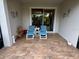 Covered patio with tiled floor, outdoor seating, and sliding glass doors to interior at 3205 Sonesta Ct # B, Clermont, FL 34711