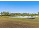 Scenic pond view surrounded by lush landscaping, mature trees, and a charming gazebo in a serene community setting at 3205 Sonesta Ct # B, Clermont, FL 34711