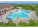 Large community pool area with plenty of lounge chairs for residents to enjoy, partially surrounded by a fence at 3205 Sonesta Ct # B, Clermont, FL 34711