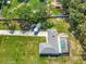 Drone image showing backyard pool, mature trees, open lawn and extra parking at 3380 Blossom St, Kissimmee, FL 34746