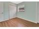 Bright bedroom featuring a closet for storage, wood flooring and window at 3380 Blossom St, Kissimmee, FL 34746
