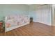 Bedroom featuring hardwood floors, twin bed and a closet for storage at 3380 Blossom St, Kissimmee, FL 34746