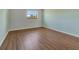 Empty bedroom has hardwood floors and a large window providing ample natural light at 3380 Blossom St, Kissimmee, FL 34746