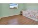 Bedroom showcasing natural light, hardwood floors and a twin bed at 3380 Blossom St, Kissimmee, FL 34746