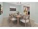 Light and airy dining room with table set for six and window view at 3380 Blossom St, Kissimmee, FL 34746