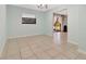Large, empty room with tile flooring, light-blue walls and natural lighting at 3380 Blossom St, Kissimmee, FL 34746