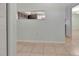 View of the spacious, empty room with tile flooring and light-blue painted walls at 3380 Blossom St, Kissimmee, FL 34746