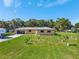 Lovely brick house boasts an open garage and spacious lawn with newly planted shrubbery at 3380 Blossom St, Kissimmee, FL 34746