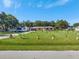 The lush front yard has an extra-long driveway with ample parking and mature trees at 3380 Blossom St, Kissimmee, FL 34746