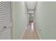 Hallway with tile flooring, neutral paint, and doors at 3380 Blossom St, Kissimmee, FL 34746