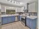 Beautiful kitchen showcasing stainless steel appliances, white cabinets, and stylish backsplash at 3380 Blossom St, Kissimmee, FL 34746