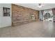 Living room features a brick accent wall with a fireplace, tile flooring, and sliding glass doors at 3380 Blossom St, Kissimmee, FL 34746