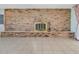 Living room features a brick accent wall with a fireplace and tile flooring at 3380 Blossom St, Kissimmee, FL 34746