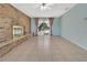 Living room features a brick accent wall with a fireplace, tile flooring, and sliding glass doors at 3380 Blossom St, Kissimmee, FL 34746