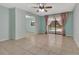 Bright living room features tile floors, a ceiling fan, and sliding glass doors to the pool at 3380 Blossom St, Kissimmee, FL 34746